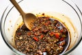 mixing crushed pepper into a bowl of soy marinade Royalty Free Stock Photo