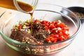 mixing crushed pepper into a bowl of soy marinade Royalty Free Stock Photo