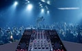 Mixing desk in nightclub party with lightshow Royalty Free Stock Photo