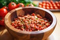 mixing diced tomatoes in a wooden bowl Royalty Free Stock Photo