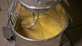 Mixing dough for bread baking with professional kneader spiral machine at the manufacturing. The dough is kneaded for