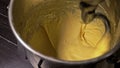 Mixing dough for bread baking with professional kneader spiral machine at the manufacturing. The dough is kneaded for