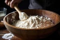 mixing dough in a ceramic bowl with wooden spoon