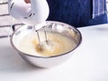 Mixing egg cream in bowl with motor mixer Royalty Free Stock Photo