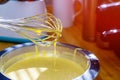 Mixing egg, flour and sugar cream bowl with motor mixer. Kneaded dough for baking a cake Royalty Free Stock Photo