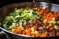 mixing leftover meat and veggies for bubble and squeak Royalty Free Stock Photo