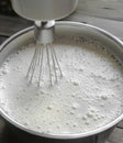 Mixing the liquid dough with a whisk. Whisk in a bowl with pancake dough. liquid pancake dough with superzu bubbles.