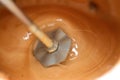 mixing milk, sugar and coffee to make a cappuccino with foam by a handheld milk frother electric mixer for coffee drink Royalty Free Stock Photo