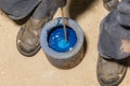 Worker are mixing up old blue paint with drill Royalty Free Stock Photo