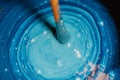 Mixing up old blue paint with drill Royalty Free Stock Photo