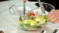 Mixing of vegetables in a glass bowl.