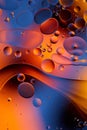 Mixing water and oil, beautiful color abstract background based on red and yellow circles and ovals, macro abstraction