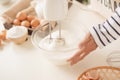 Mixing white egg cream in bowl with motor mixer, baking cake Royalty Free Stock Photo