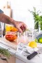 Mixologist making refreshing cocktail with hard seltzer at home