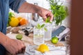 Mixologist making refreshing cocktail with hard seltzer at home