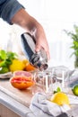 Mixologist making refreshing cocktail with hard seltzer at home