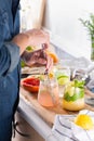 Mixologist making refreshing cocktails with hard seltzer at home Royalty Free Stock Photo