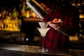 Mixologist pouring fresh and sour drink into a cocktail glass Royalty Free Stock Photo