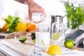 Mixologist making refreshing cocktail with hard seltzer at home