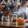 A mixologist using a smoking gun to infuse a cocktail with aromatic smokiness1