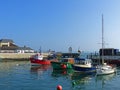 A mixture of boats on their moorings in the small harbour in the so called proud Cobh of Cork in Ireland on a beautiful day.