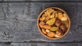 A mixture of dried fruits and various nuts on a wooden table. Flat lay Royalty Free Stock Photo