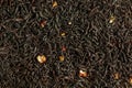 A mixture of dry black tea and pieces of dried strawberries as a background Royalty Free Stock Photo