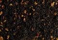 A mixture of dry black tea and dry tea rose petals as a background Royalty Free Stock Photo