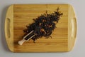 A mixture of dry black tea and dry tea rose petals as a background. Isolated on a wooden surface Royalty Free Stock Photo