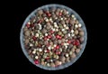 Mixture of dry pepper peas black, red, white colors in crystal plate