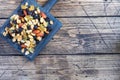 A mixture of nuts and dried fruits on a wooden chopping board, rustic background. Concept of healthy food. Copy space Royalty Free Stock Photo