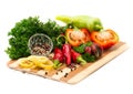 Mixture of peppers with greens on a wooden board Royalty Free Stock Photo