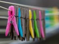 Mixture of plastic and wooden clothes pegs hanging from a clothes line. Air drying is more environmentally friendly than using a c Royalty Free Stock Photo