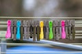 Mixture of plastic and wooden clothes pegs hanging from a clothes line. Air drying is more environmentally friendly than using a c Royalty Free Stock Photo