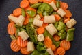 A mixture of vegetables: carrots, small heads of corn, asparagus beans steamed