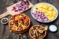 Mixture of vegetables, dried boletus mushrooms, sliced potato, red onion sliced and whole on a cutting board and spices Royalty Free Stock Photo