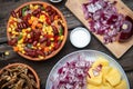 Mixture of vegetables, dried boletus mushrooms, sliced potato, red onion sliced and whole on a cutting board and spices Royalty Free Stock Photo