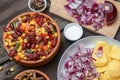 Mixture of vegetables, dried boletus mushrooms, sliced potato, red onion sliced and whole on a cutting board and spices Royalty Free Stock Photo