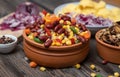 Mixture of vegetables, dried boletus mushrooms, sliced potato, red onion sliced and whole on a cutting board and spices Royalty Free Stock Photo