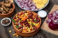 Mixture of vegetables, dried boletus mushrooms, sliced potato, red onion sliced and whole on a cutting board and spices Royalty Free Stock Photo