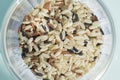 A mixture of wild rice grains: yellow, brown and black in a glass bowl. Plov preparation Royalty Free Stock Photo