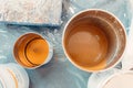 Preparator pours chemical components for epoxy resin floors from the tin bucket