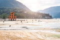 MIYAJIMA, JAPAN - MARCH 25: Tourists walk around the famous floating torii gate - Itsukushima Shrine, Miyajima Royalty Free Stock Photo