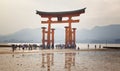 MIYAJIMA, JAPAN - MAY 27: Tourists walk around the famous floating torii gate of the Itsukushima Shrine on Miyajima at low tide sh Royalty Free Stock Photo