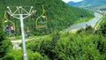 MIZHHIRIA, UKRAINE - JULY 1, 2018: Enjoy the ski lift ride to the top of Makovytsia Mountain with a view on Rika River, stretchin