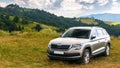 Suv on a hillside meadow Royalty Free Stock Photo