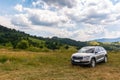 Suv on a hillside meadow