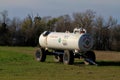 MKC Anhydrous Ammonia tank in a farm field out in the country with blue sky in Kansas.