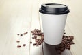 330 ml disposable coffee paper cup with beans on white wooden table Royalty Free Stock Photo