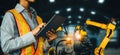 MLP Engineer use advanced robotic software to control industry robot arm in factory Royalty Free Stock Photo